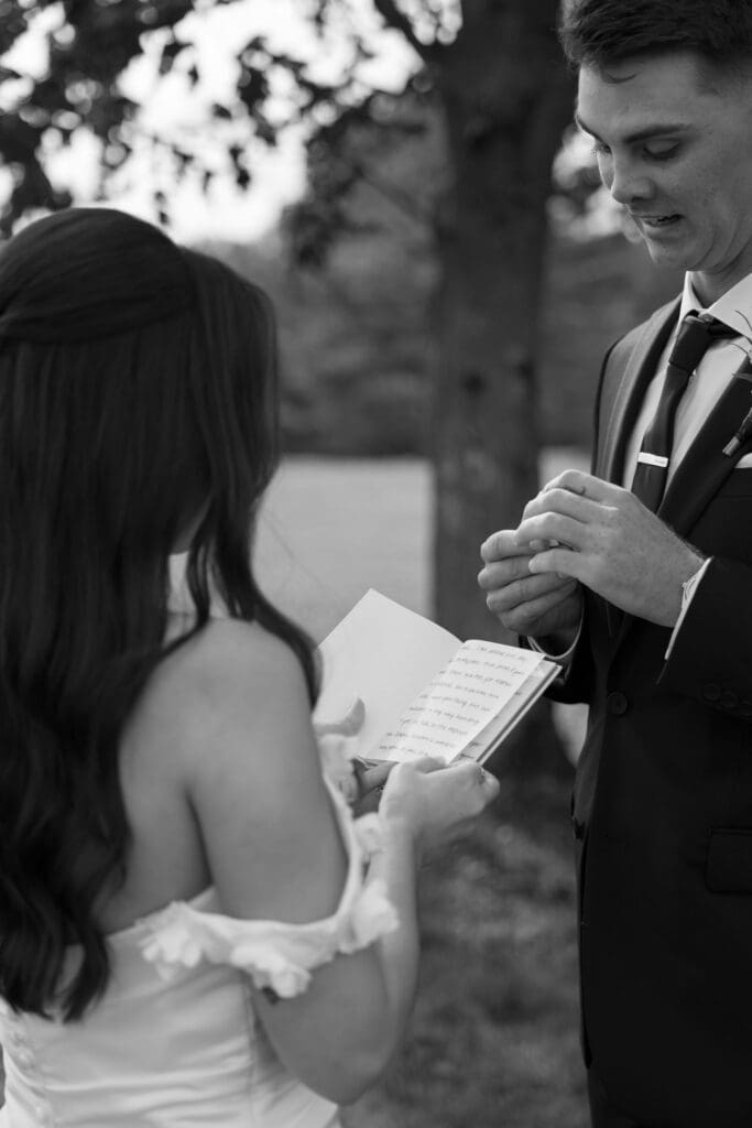 A black-and-white close-up shows the couple reading their vows face to face in a candid ceremony moment from wedding photographers CT.